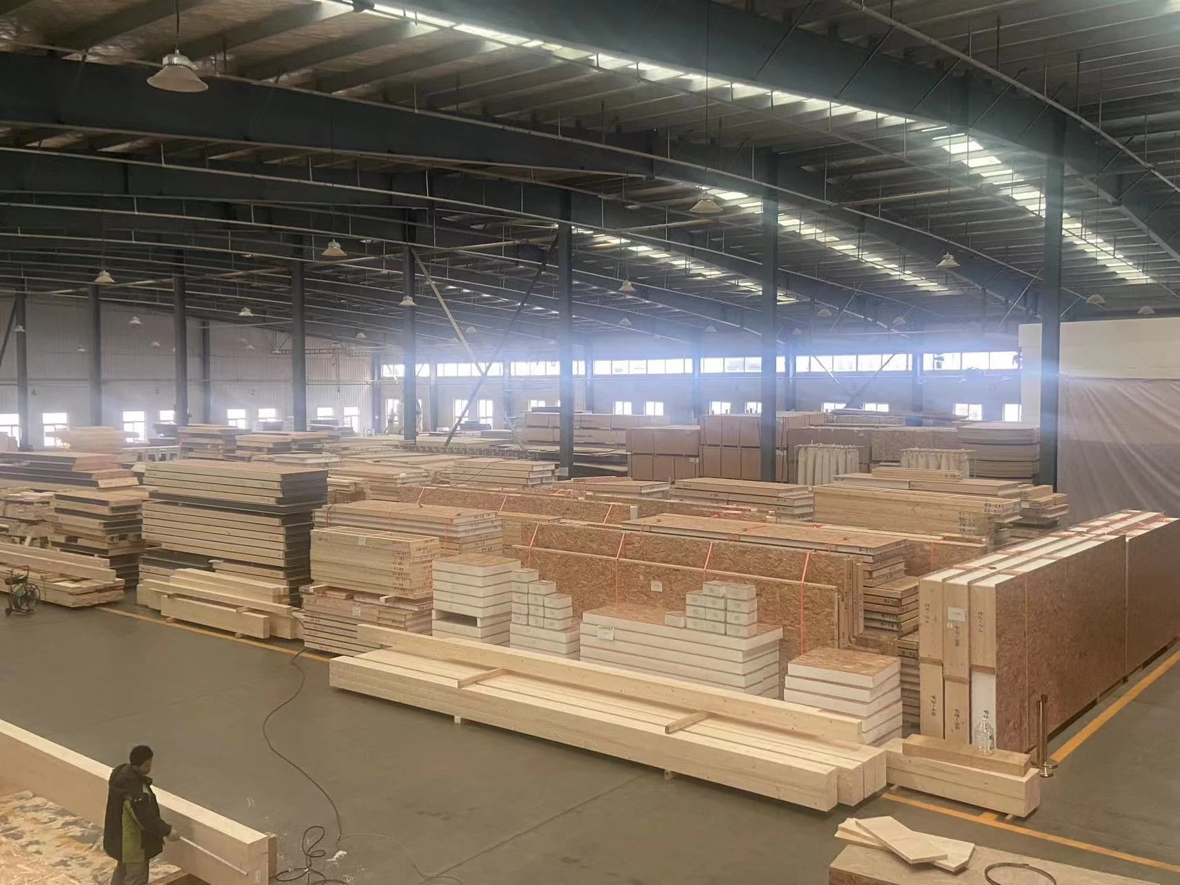Prepared SIP panels and timber components arranged in the Quacent production facility.