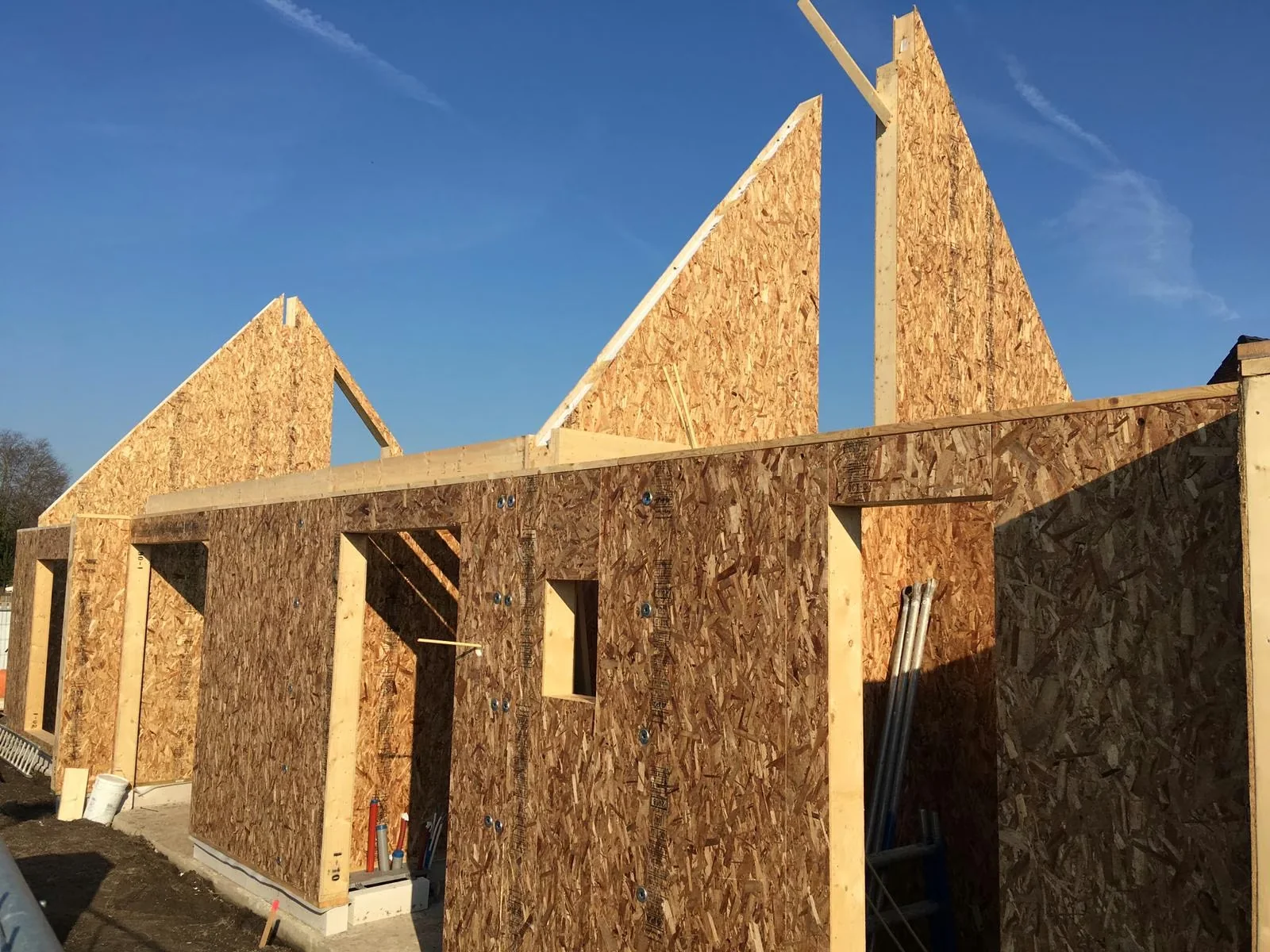 SIP gable wall with a timber beam and framed openings.