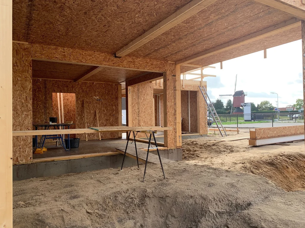Interior of a SIP shell showing openings, panel surfaces and timber interfaces.