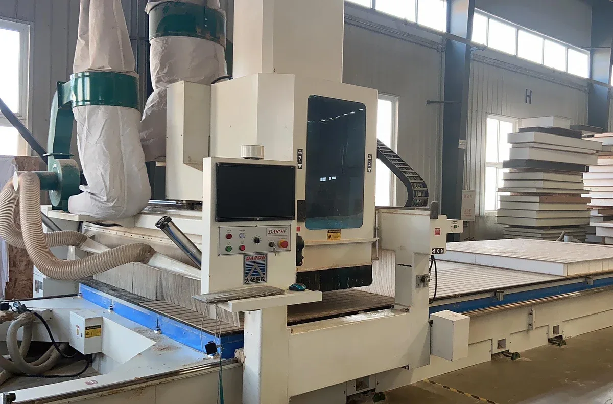 Panel-processing machine and extraction equipment in a factory